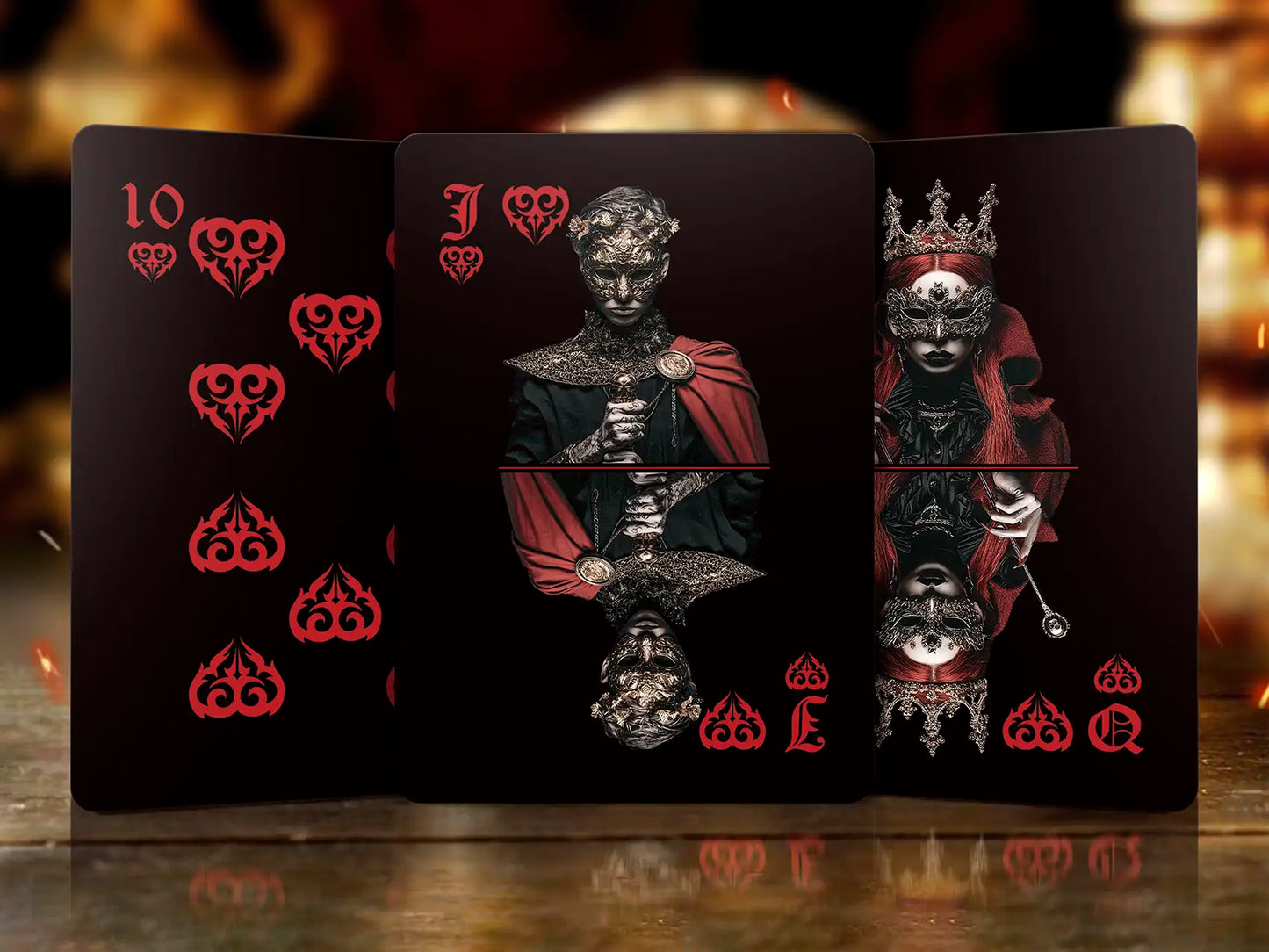 Three playing cards with intricate designs and symbols on a dark background