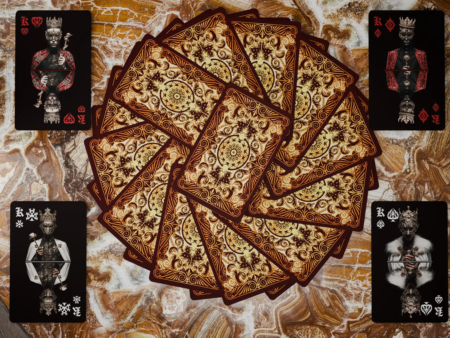 Decorative playing cards with intricate designs on a textured surface