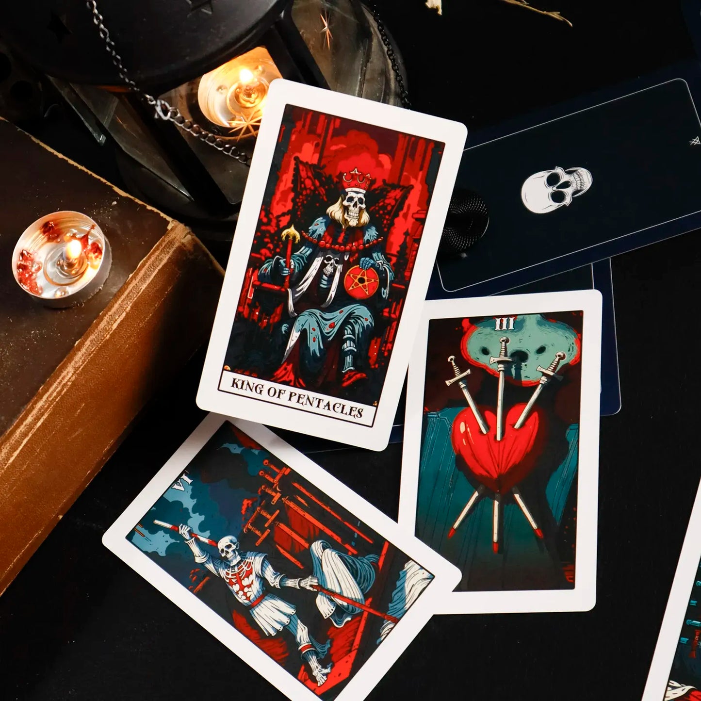Tarot cards with a dark, mystical theme on a black surface.