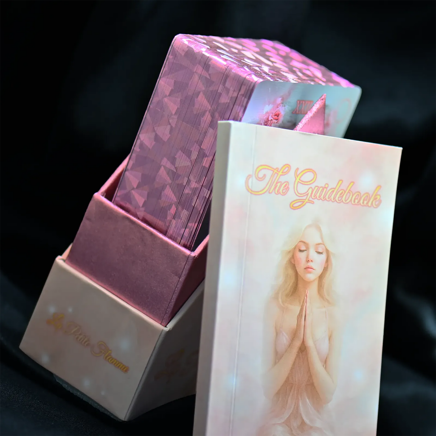 Card deck with 'The Gilded Deck' cover featuring a woman's face on a dark background