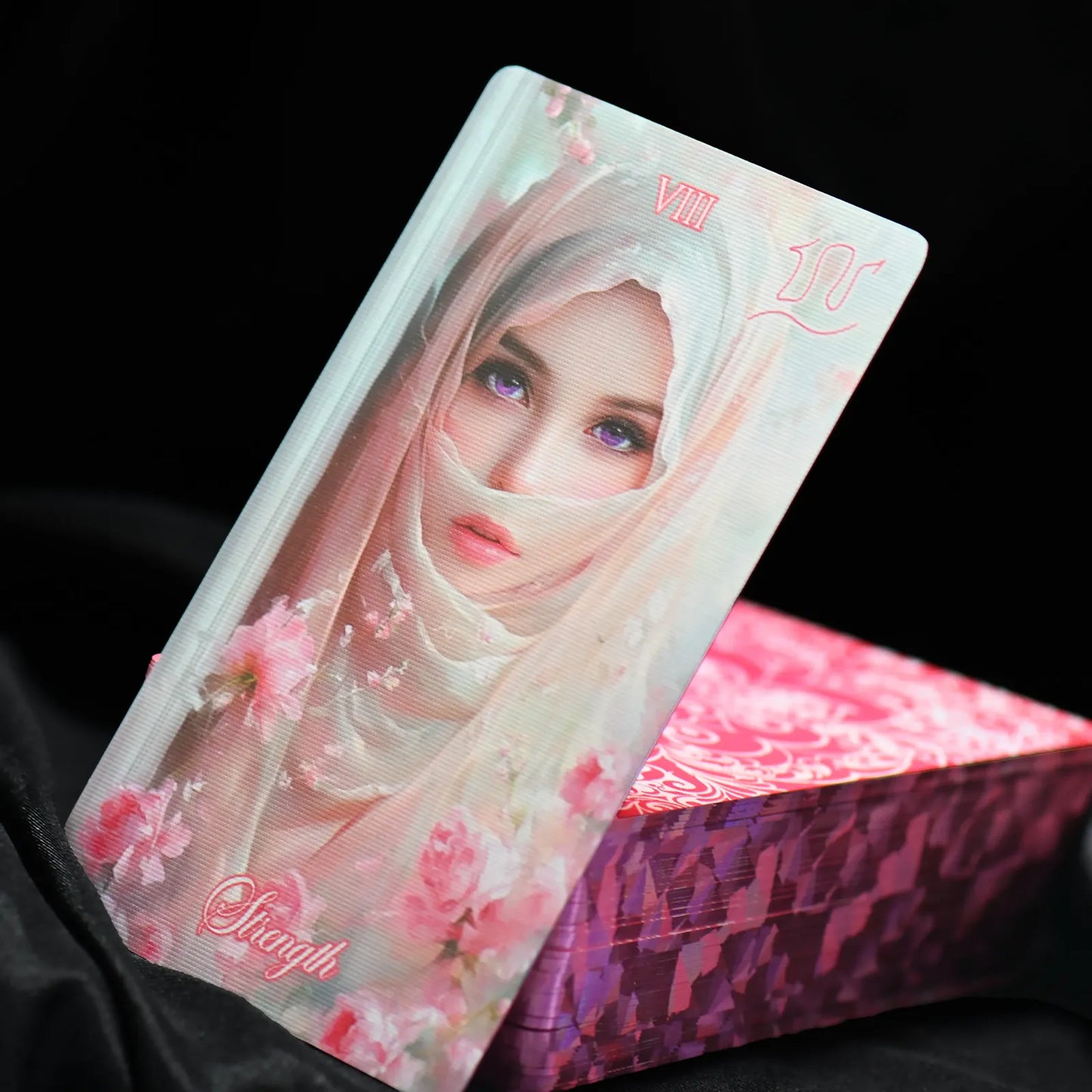 Card with a stylized face and floral design on a black background