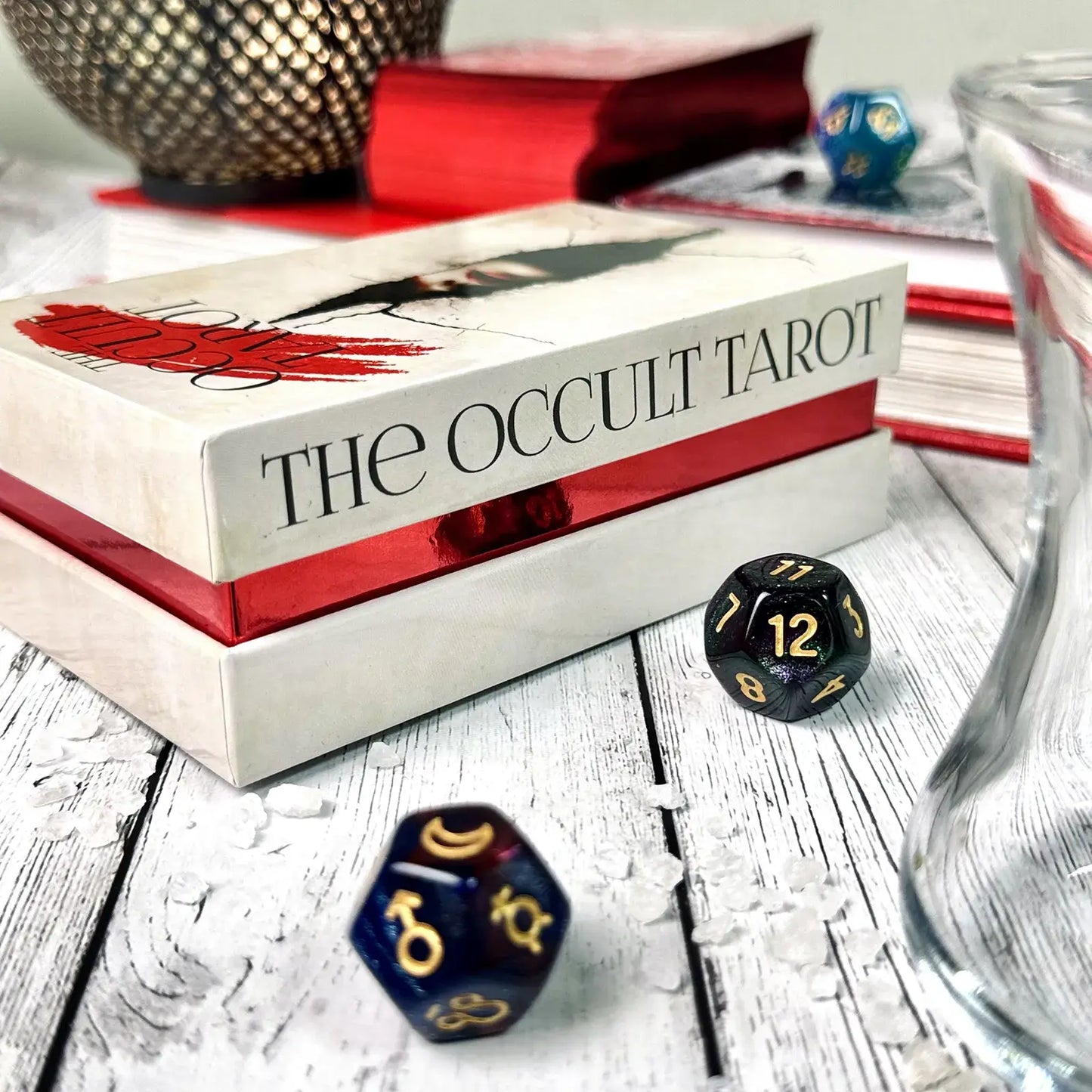 Tarot titled 'The Occult Tarot' with dice on a wooden surface