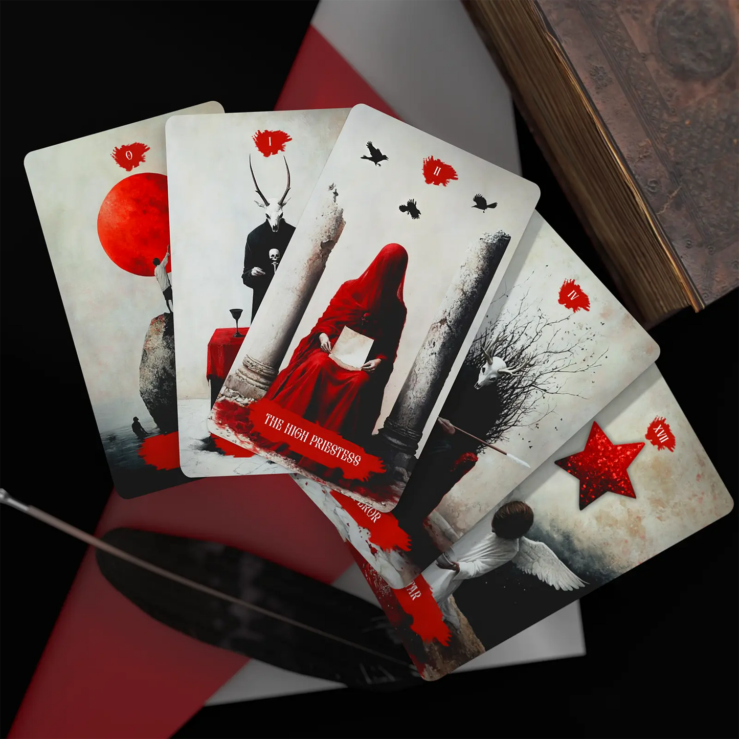 Playing cards with artistic designs and red accents on a dark surface