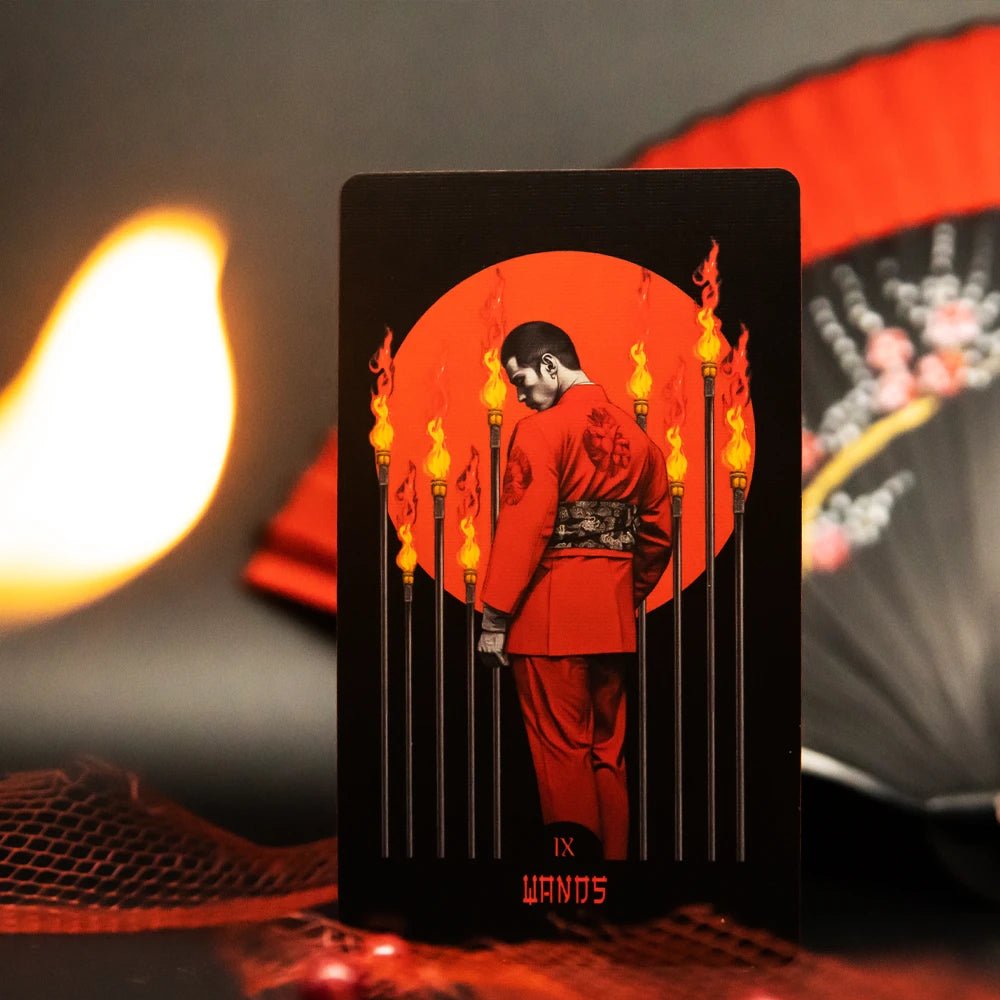 Yakuza Tarot Nine of Wands card, man in red suit among flaming torches, with red folding fan