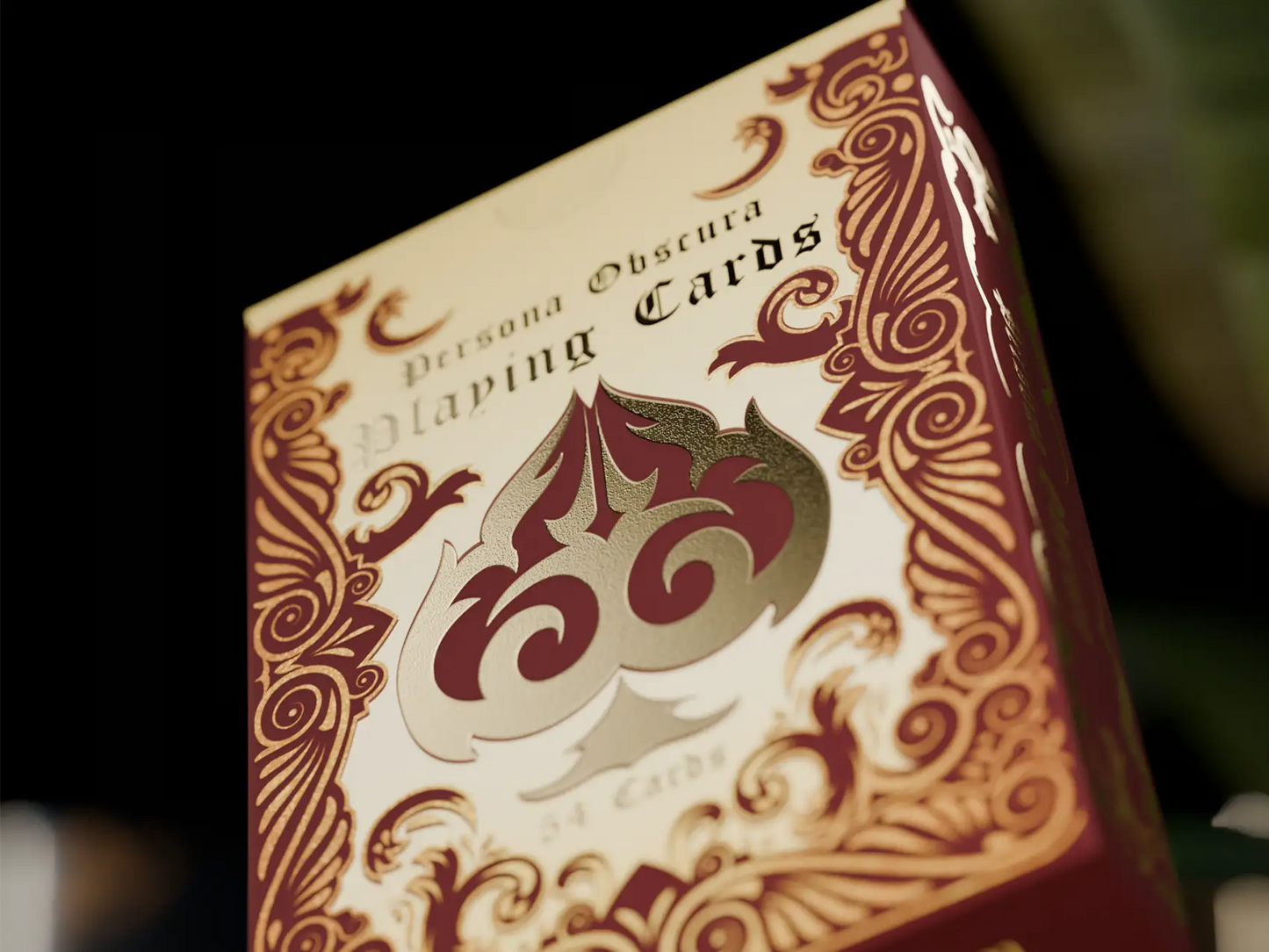 Close-up of a deck of Persona Obscura playing cards with intricate design, gold foil