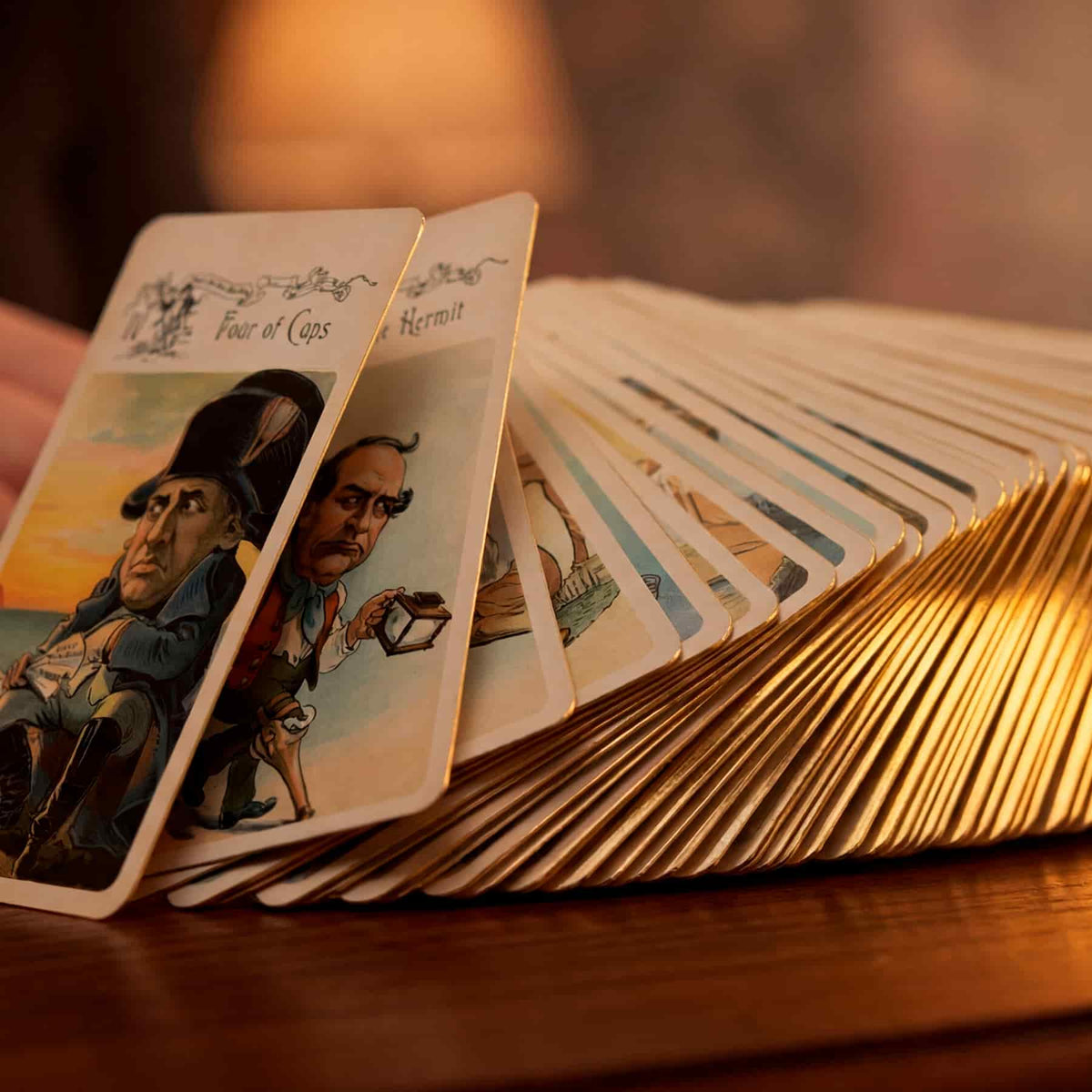Vestige Tarot cards fanned showing Four of Cups and The Hermit with gold gilded edges