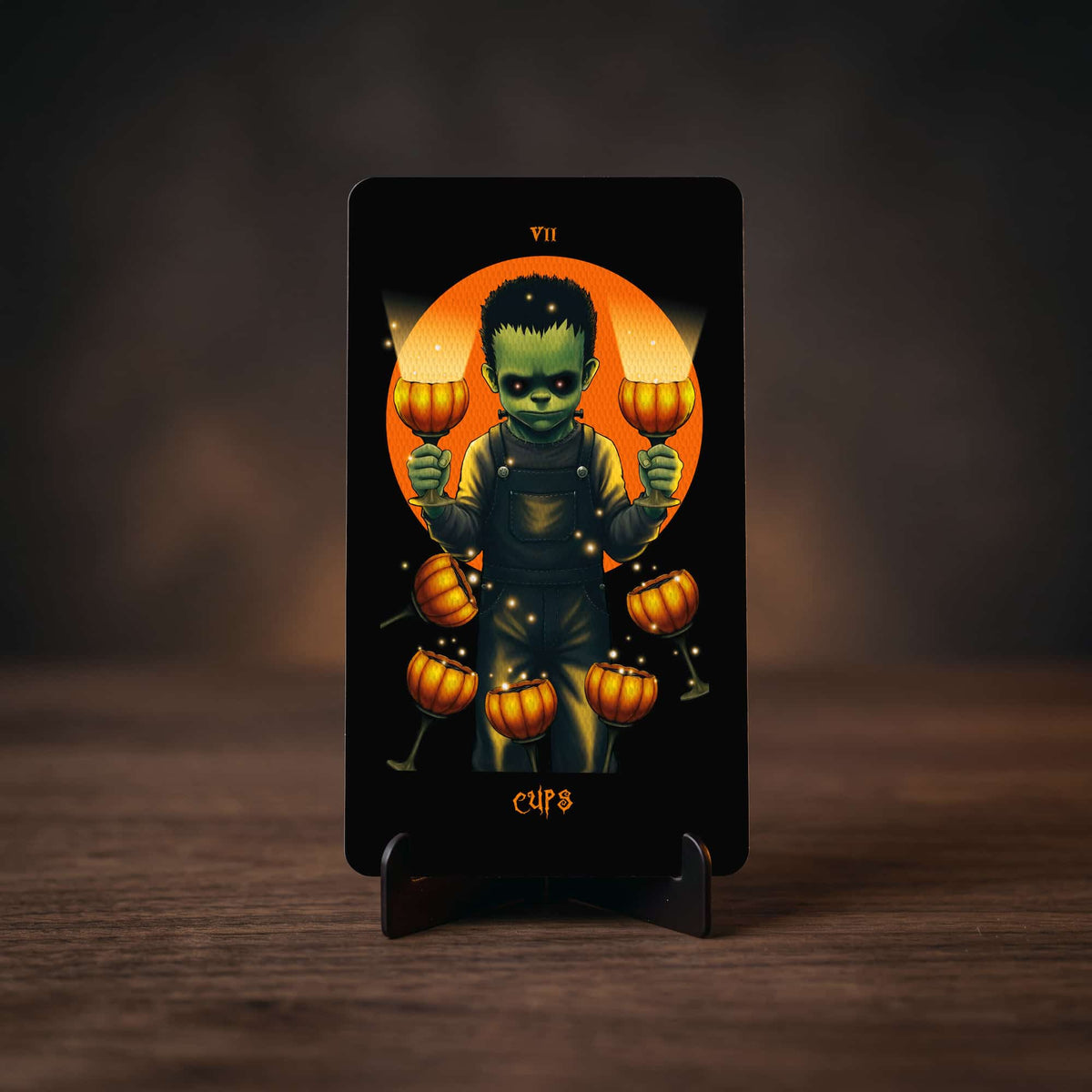 Halloween Tarot Seven of Cups card, Frankenstein-style child holding pumpkin goblets