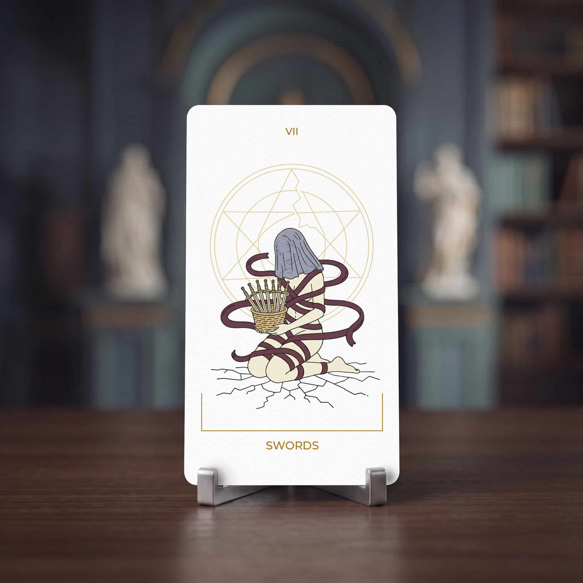 Seraphim Tarot Seven of Swords card, kneeling figure bound in ribbons holding a basket of swords