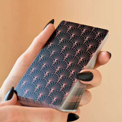 Geisha no Tamashii Tabi Lenormand deck held in hand showing black and gold Japanese pattern card backs 