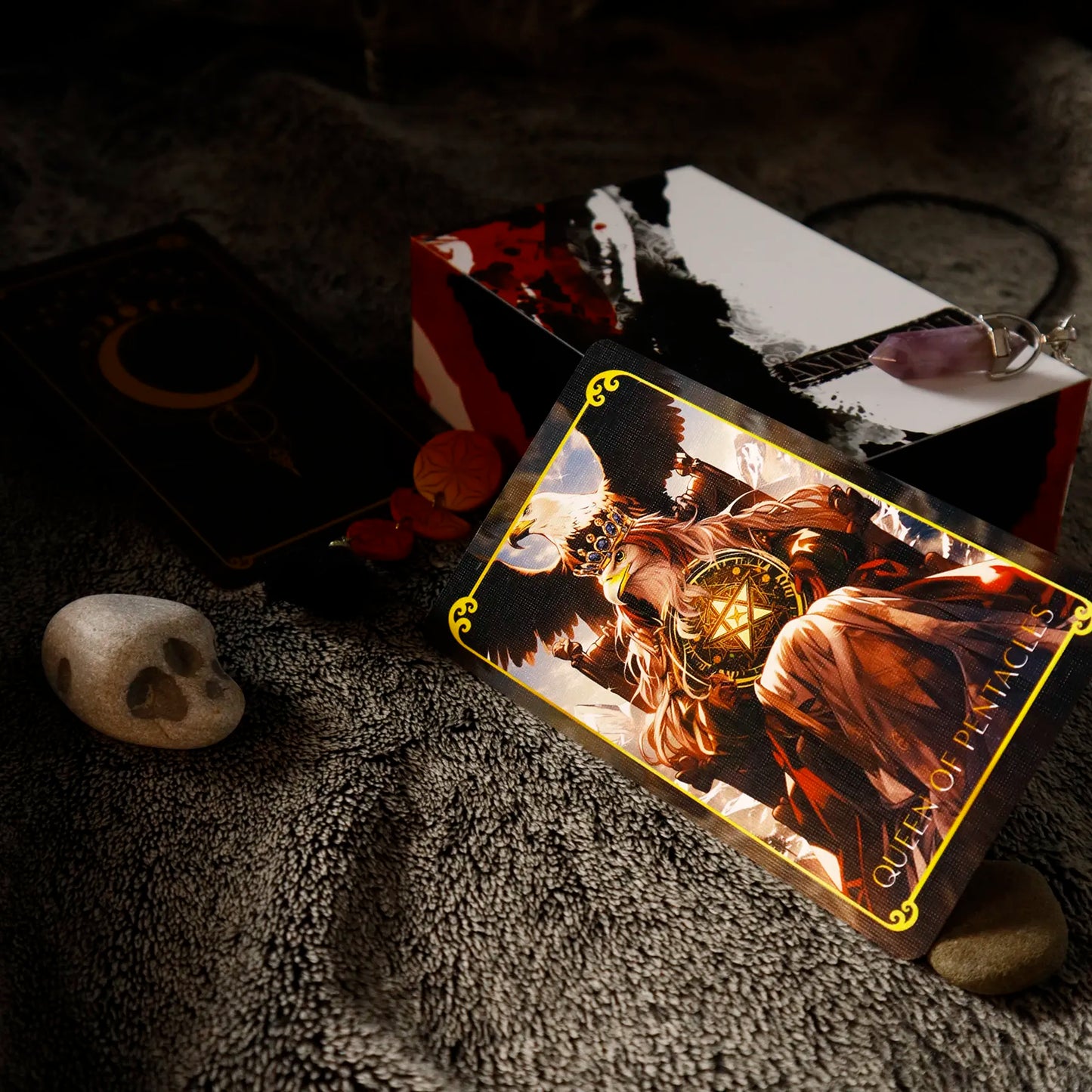 Tarot card featuring a robed figure with a crown on a textured surface with a skull and other cards in the background.