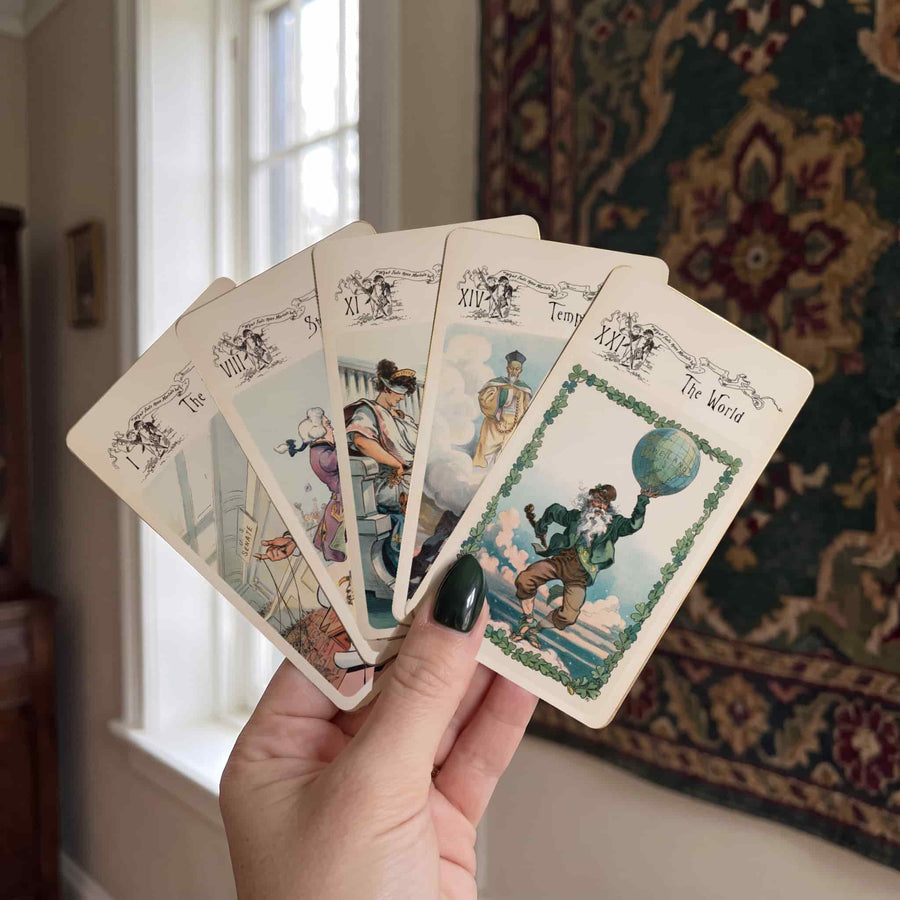 Hand fanning Vestige Tarot major arcana cards ending with The World, vintage illustrated art