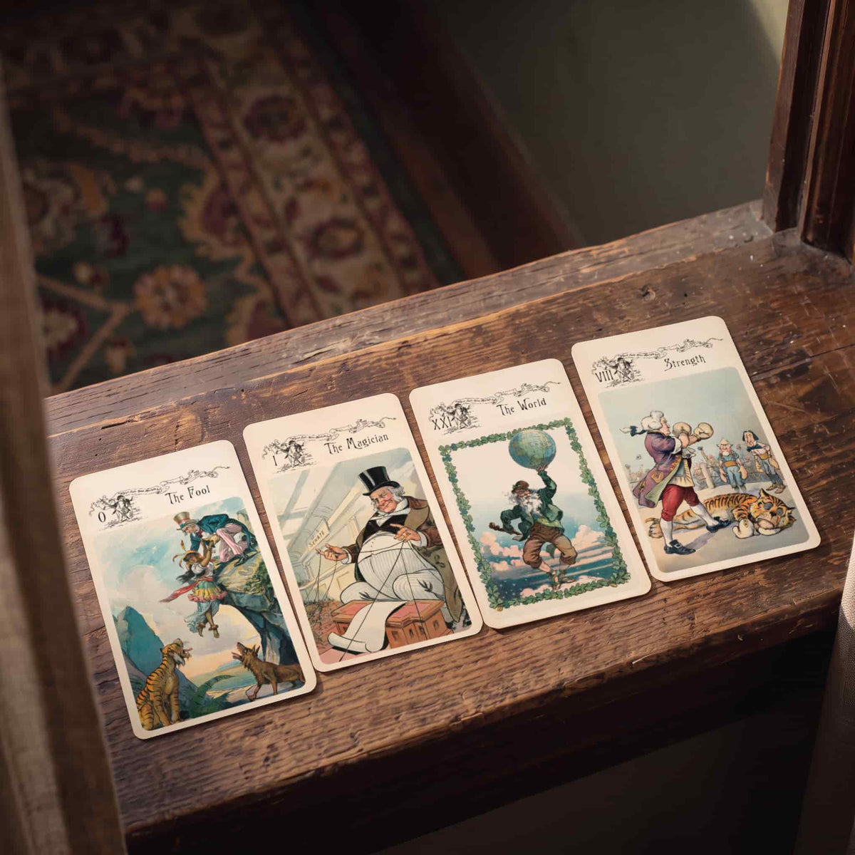 Vestige Tarot The Fool, The Magician, The World and Strength cards on a wooden windowsill