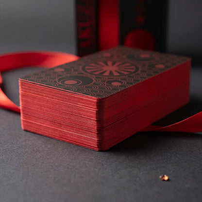 A macro detail shot showcasing the Yakuza Tarot deck’s matte red edges and thick 350gsm anti-scratch linen cardstock for a premium, durable feel. Optimized for keywords such as tarot deck quality, luxury tarot printing, thick cardstock tarot, matte edge tarot deck, and collector edition tarot cards.