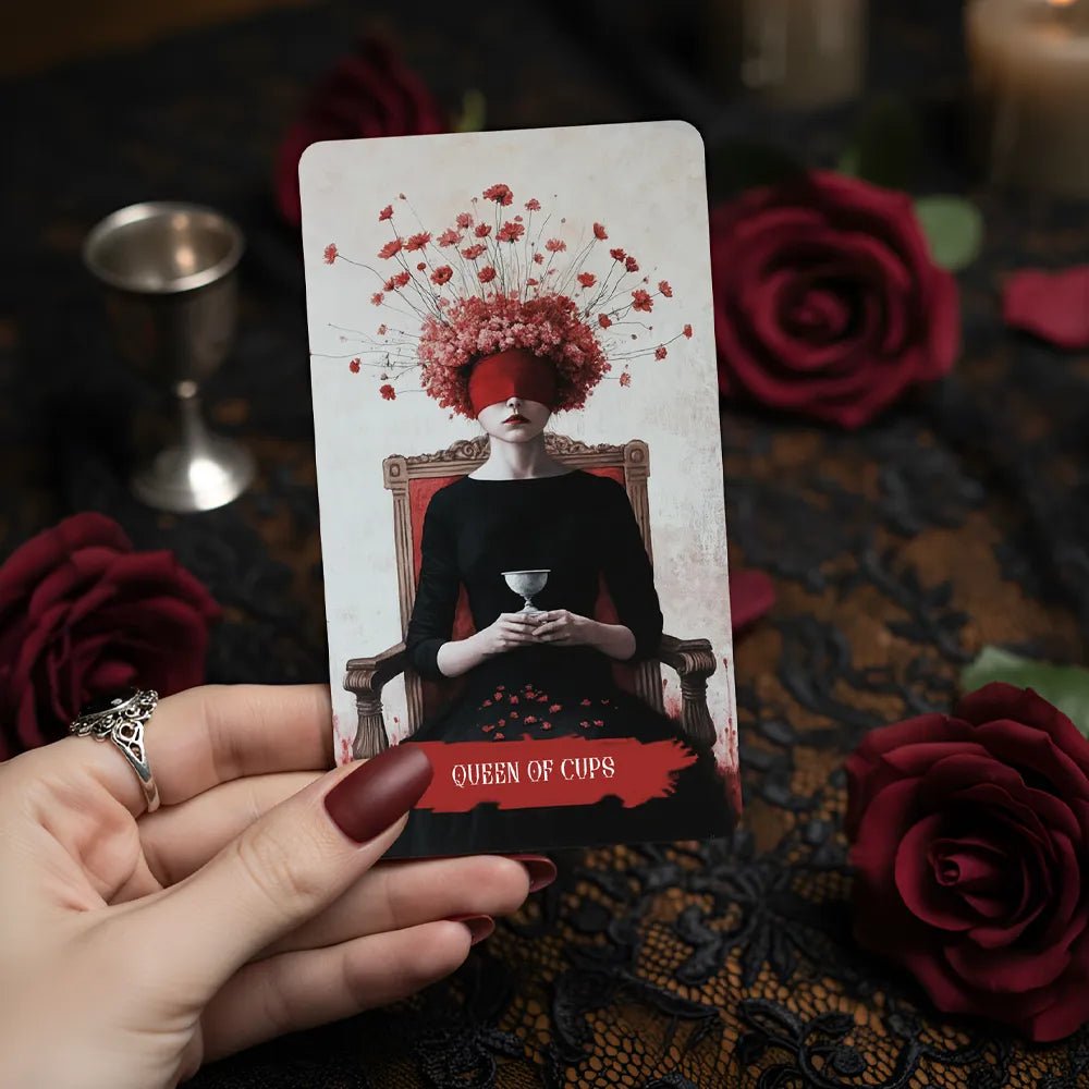 Arcana Obscura Queen of Cups tarot card held in hand with red roses gothic dark aesthetic