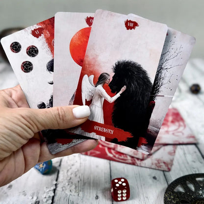 Arcana Obscura Strength tarot card held in hand with lion and angel illustration red black aesthetic