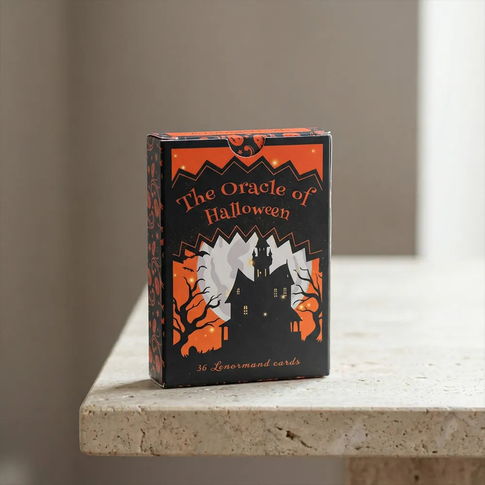 The Oracle of Halloween Lenormand deck box on a light stone surface with minimal background