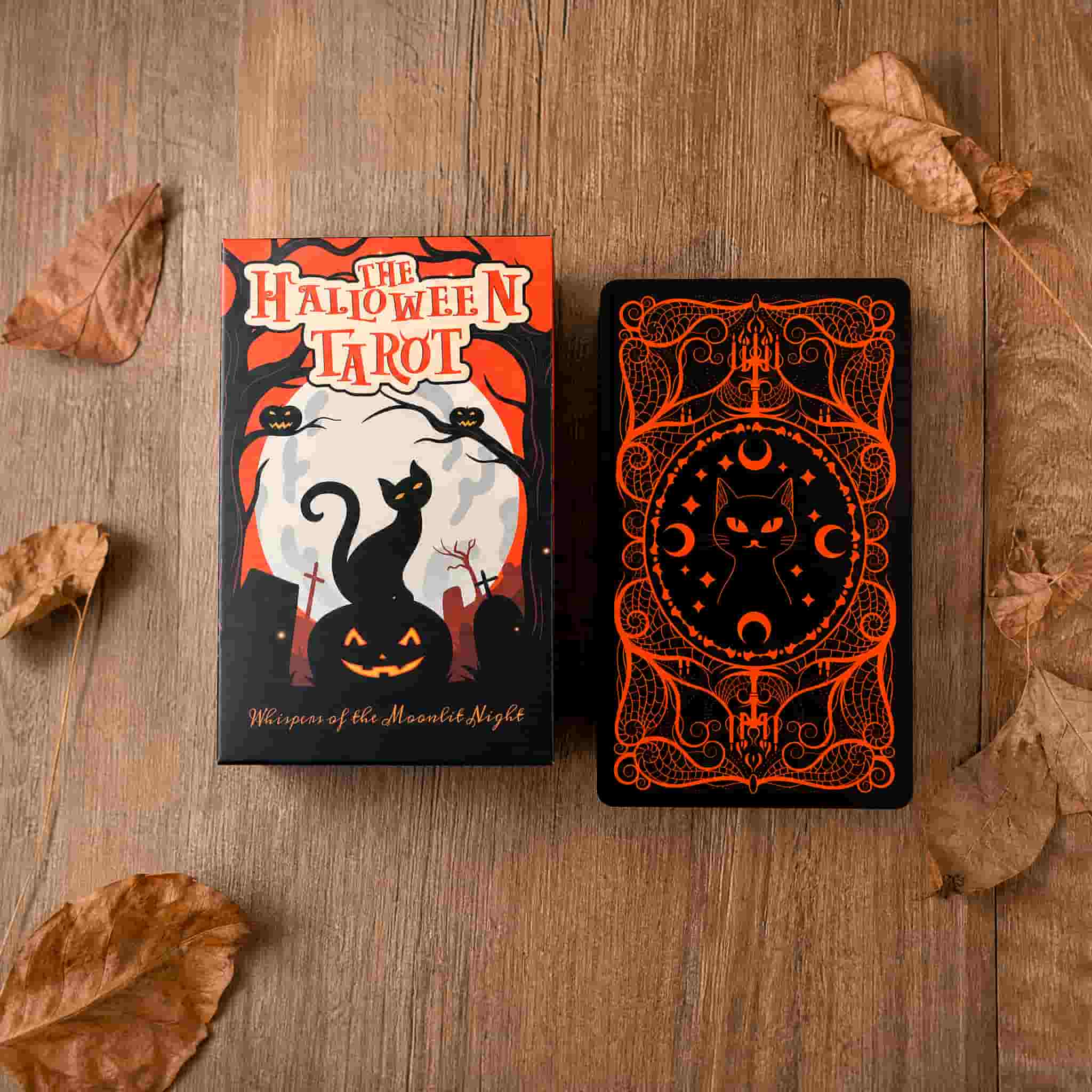 Halloween Tarot collector box and card back displayed on wooden table with pumpkin orange artwork, black cat design and autumn leaves