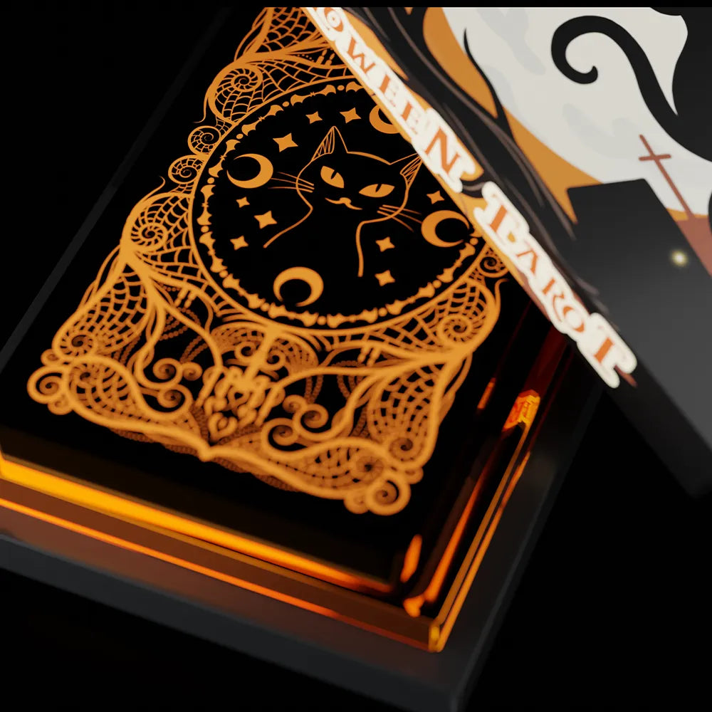 Close-up of Halloween Tarot card back with black cat design and orange foil details