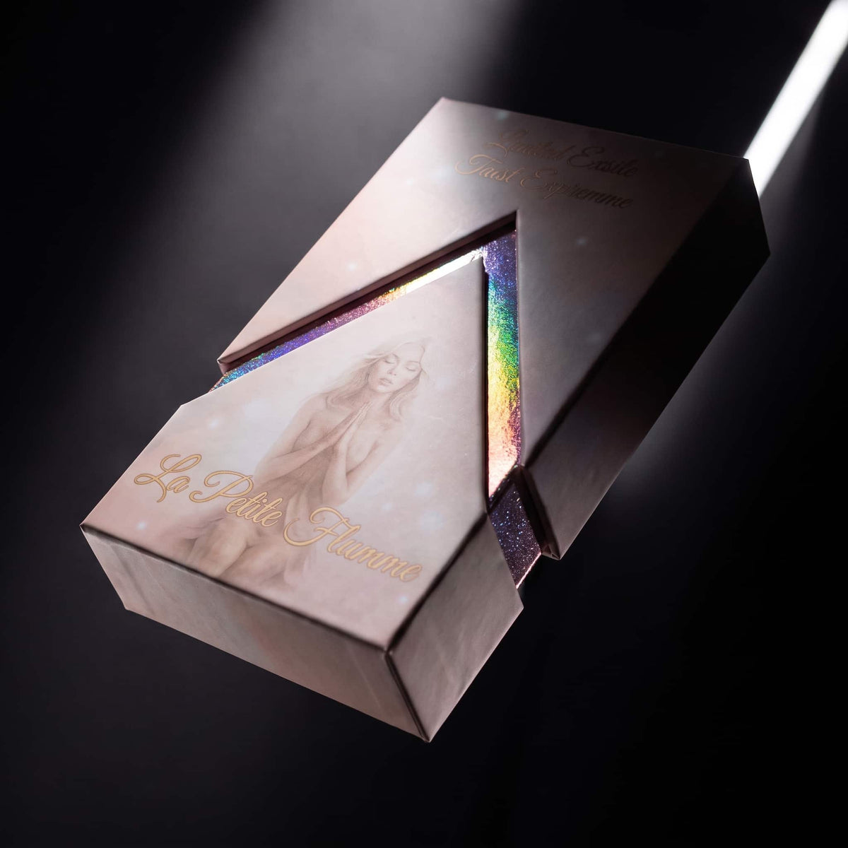 La Petite Flamme Tarot pink foiled box with holographic rainbow insert in dramatic light
