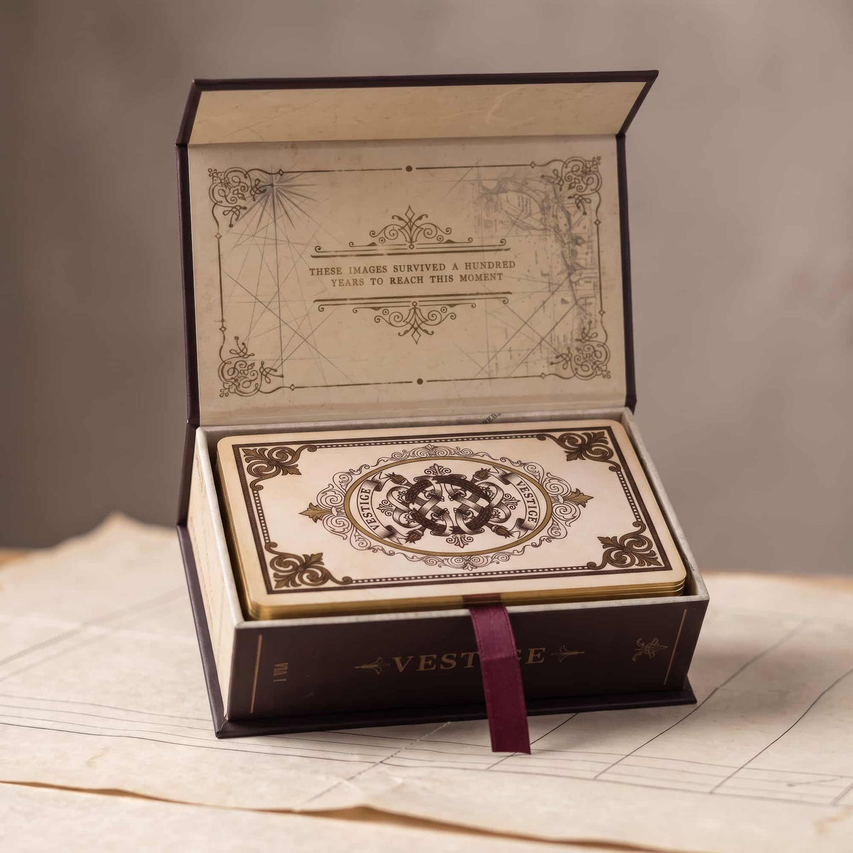 Vestige Tarot open book-style collector box with gilded deck and ribbon pull, vintage archive design