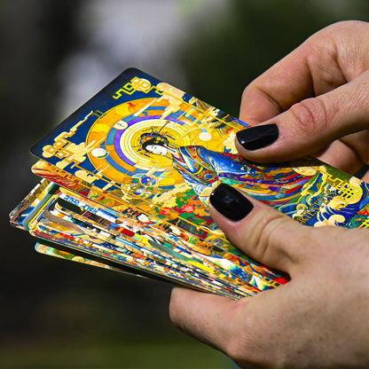 Hands holding Journey to the West Tarot cards, bright Chinese-inspired art with gold borders