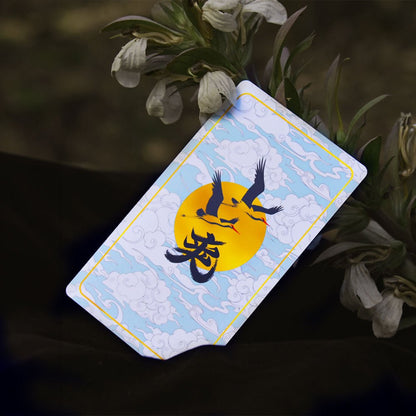 Journey to the West Tarot card back, cranes flying over a golden sun with light blue clouds