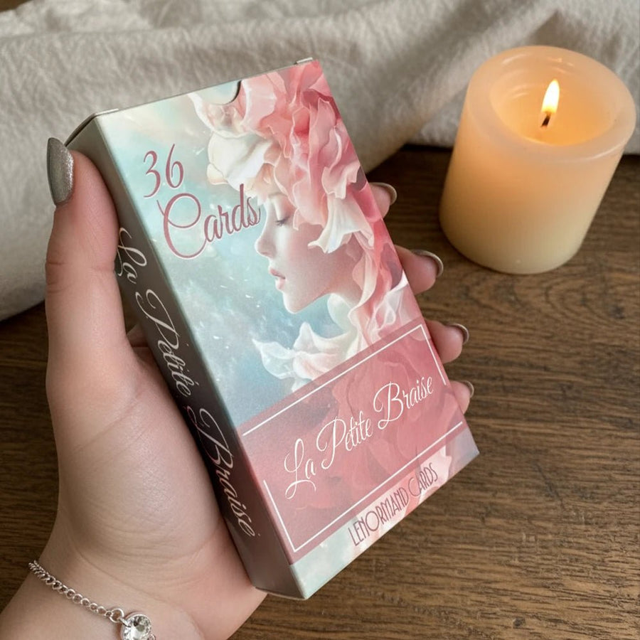 Hand holding La Petite Braise Lenormand box, 36 cards, pastel pink woman with peony