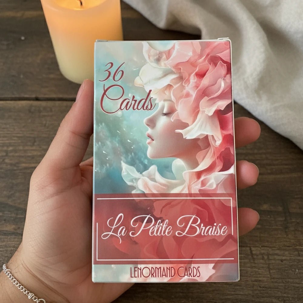 La Petite Braise Lenormand 36 cards deck box front with soft pastel feminine illustration held in hand