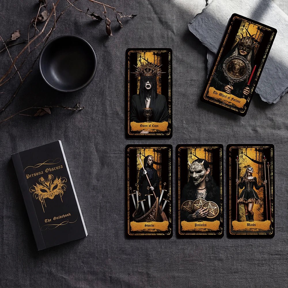 Persona Obscura Tarot spread with guidebook and five black-and-gold cards on dark stone surface
