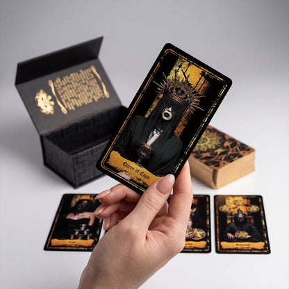 Unboxing Persona Obscura Tarot: open box and hand holding card, gold gilded edges close-up
