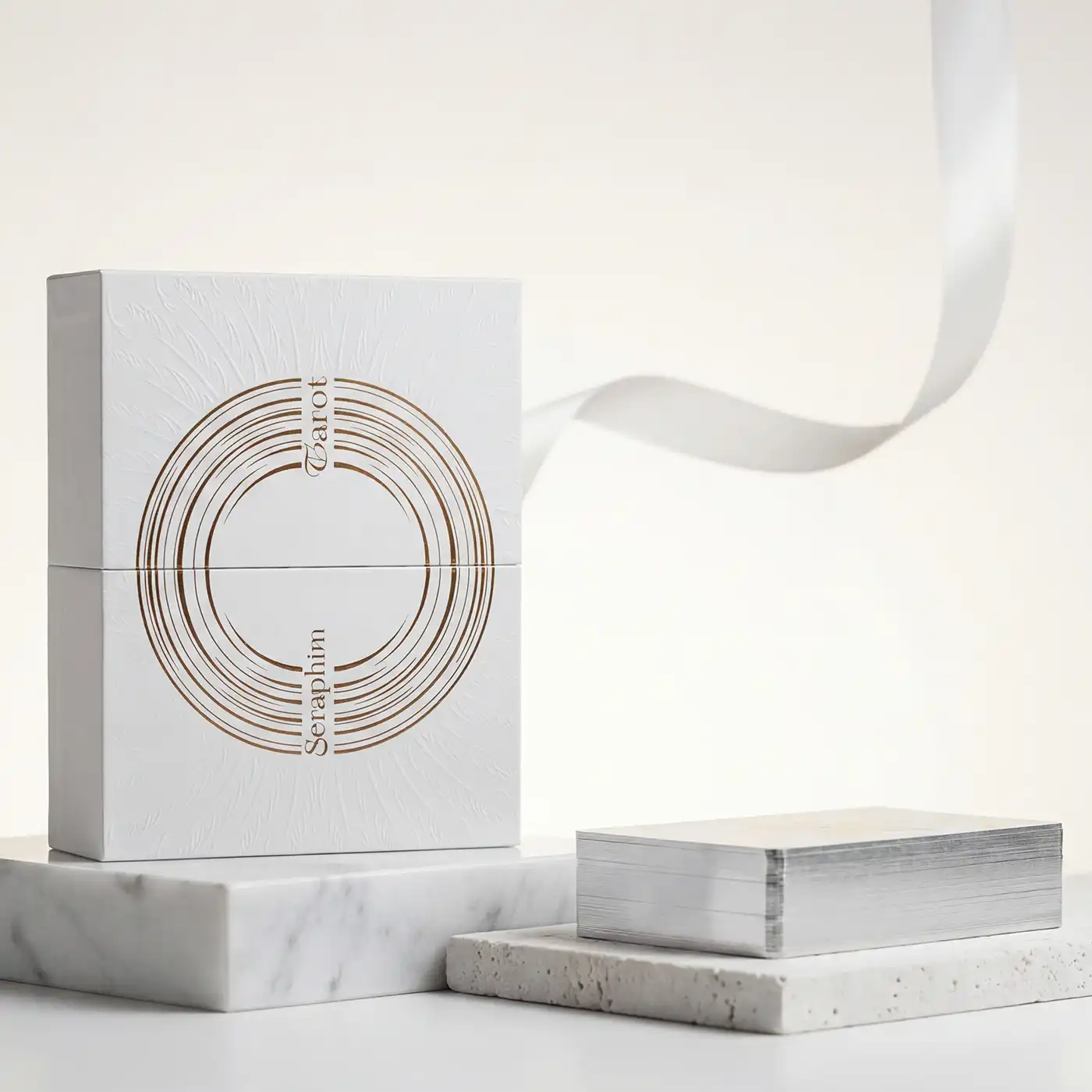 Seraphim Tarot luxury white box with gold foil design displayed on marble platform