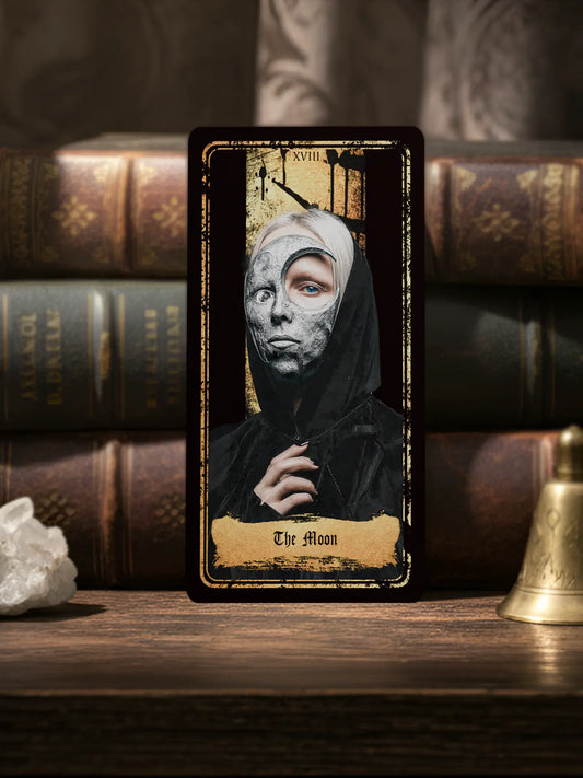 Tarot card titled 'The Moon' with a hooded figure against a dark background, surrounded by books and a crystal, 70x140mm matte finish 400gsm paper 
