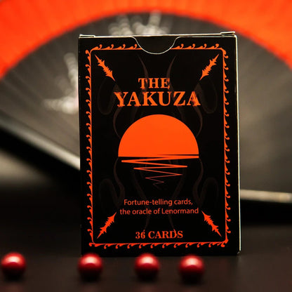Yakuza Lenormand deck box front design in black and red with rising sun symbol and minimal typography