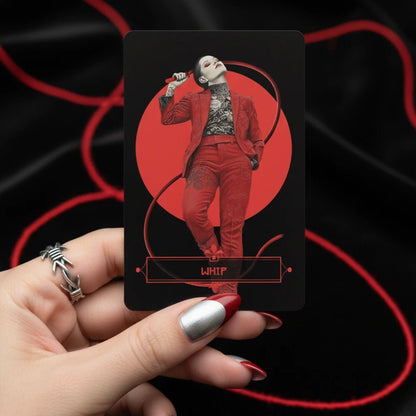 Hand holding Yakuza Lenormand Whip card featuring a woman in red suit with bold red and black design