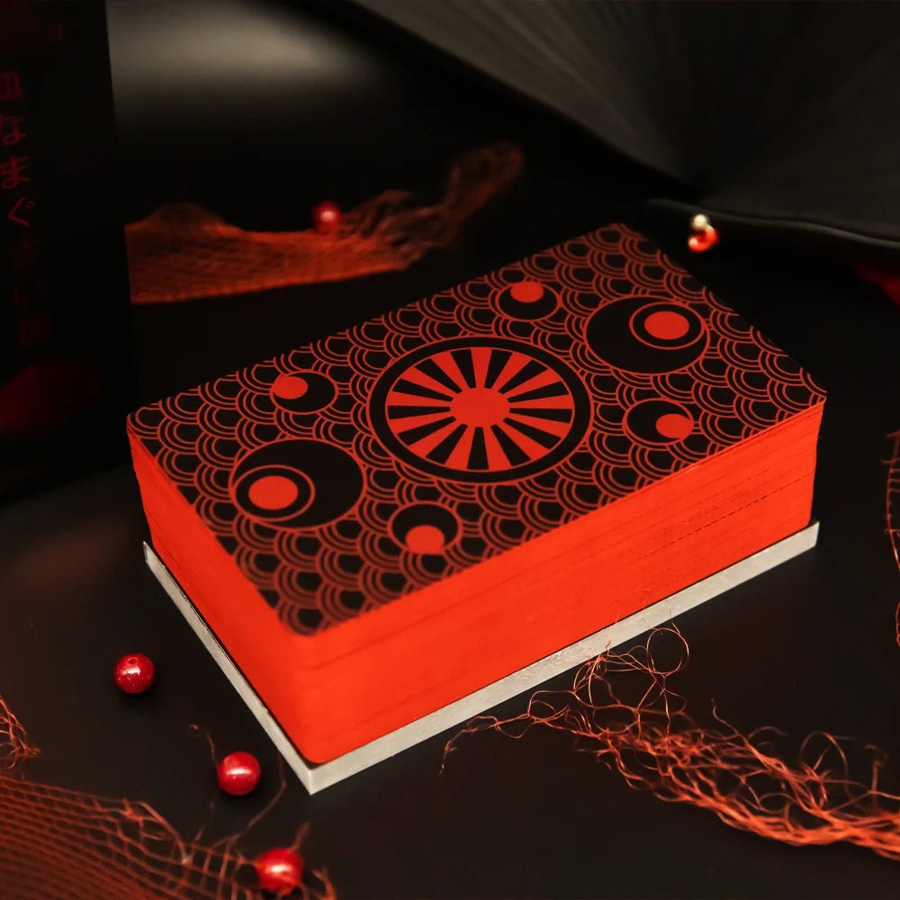 Yakuza Tarot deck card backs with red edges and geometric Japanese-inspired pattern on black