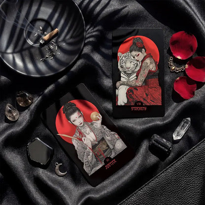 Yakuza Tarot cards Strength and Justice displayed on black silk with crystals, petals and dramatic lighting