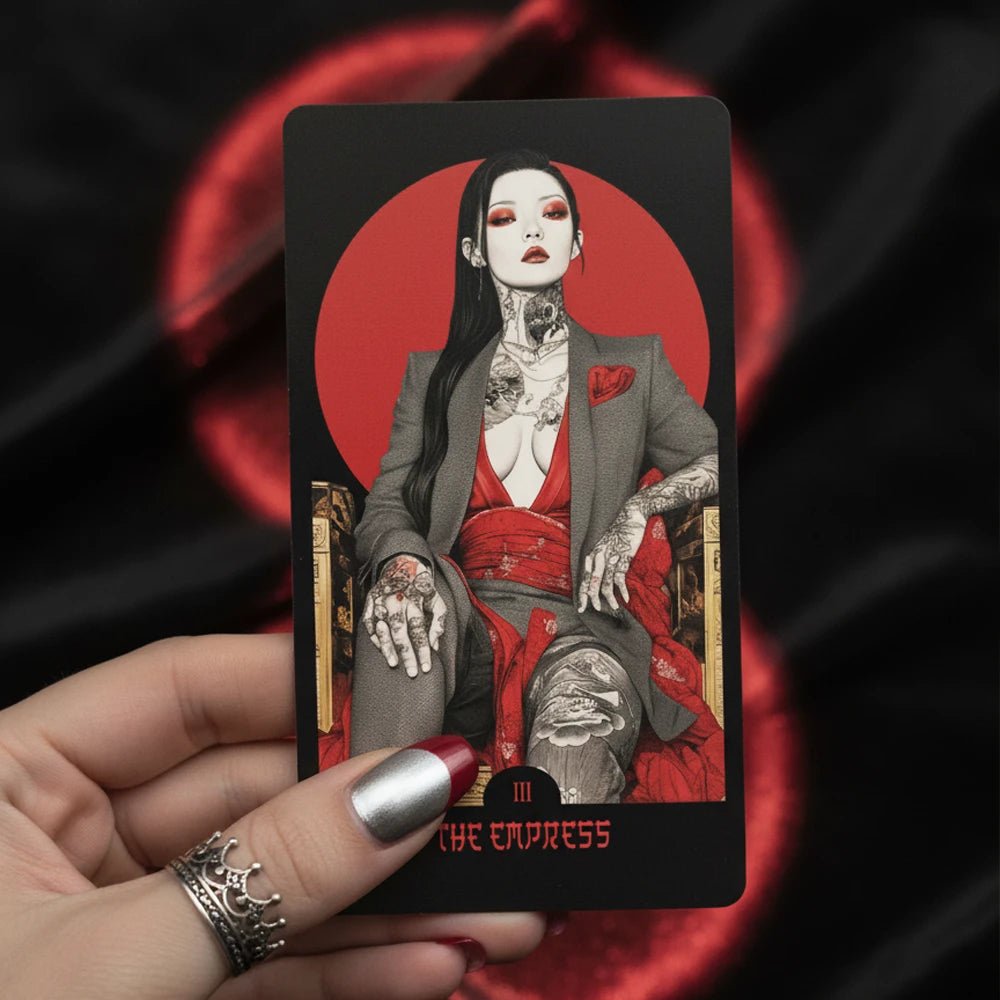 Close-up: Yakuza Tarot major arcana card in hand, red sun motif, noir illustration