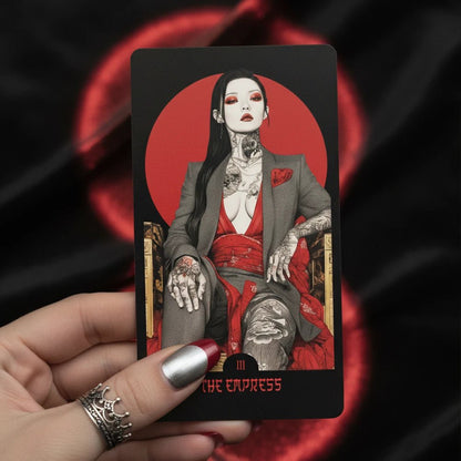 Close-up: Yakuza Tarot major arcana card in hand, red sun motif, noir illustration